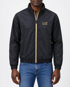Giacca bomber beige chiaro e nero indossata, vista frontale su fondo neutro